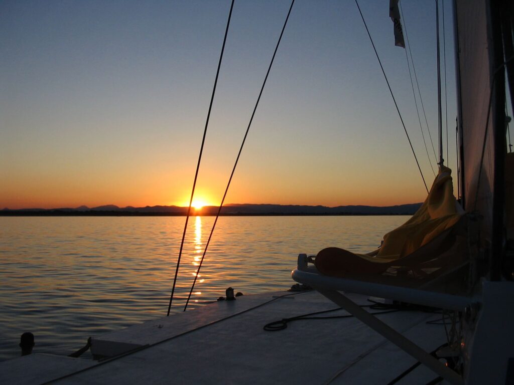 eclat-soleil-couchant-pont-bois-catamaran-voile