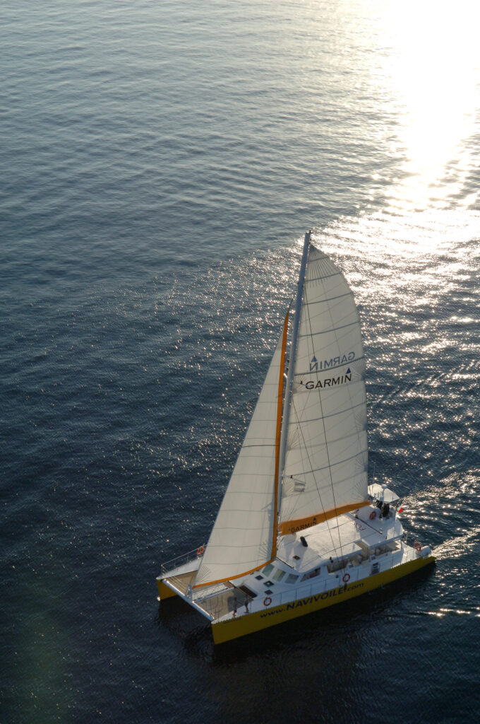 Le catamaran Navivoile naviguant sous voiles dans la brise de fin d'après-midi lors du trajet retour vers Canet-en-Roussillon