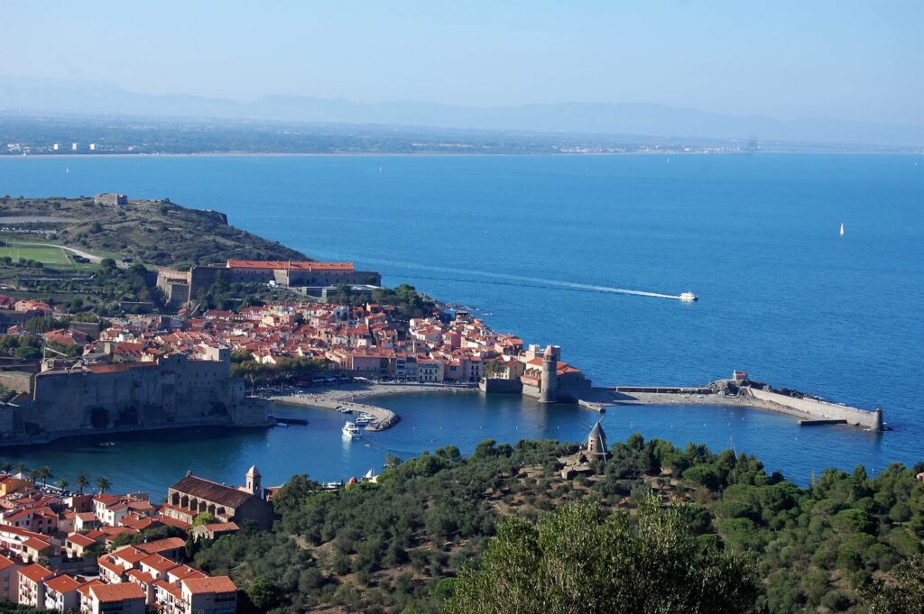Vue panoramique depuis les hauteurs du moulin de Collioure sur l'enfilade des côtes rocheuses et sablonneuses, étape phare des circuits avec le NAVIVOILE